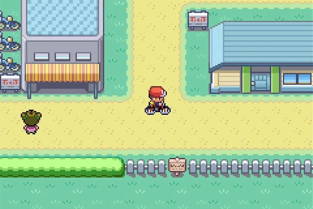 Player riding a bicycle past the Bike Shop in Cerulean City in Pokémon FireRed